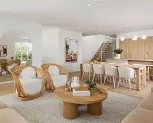 A living room with a half-wall separating it from the kitchen